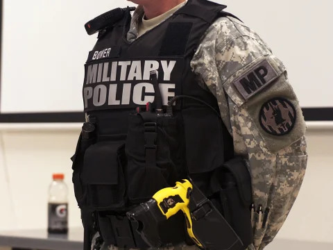 Military police tactical vest with radio and taser